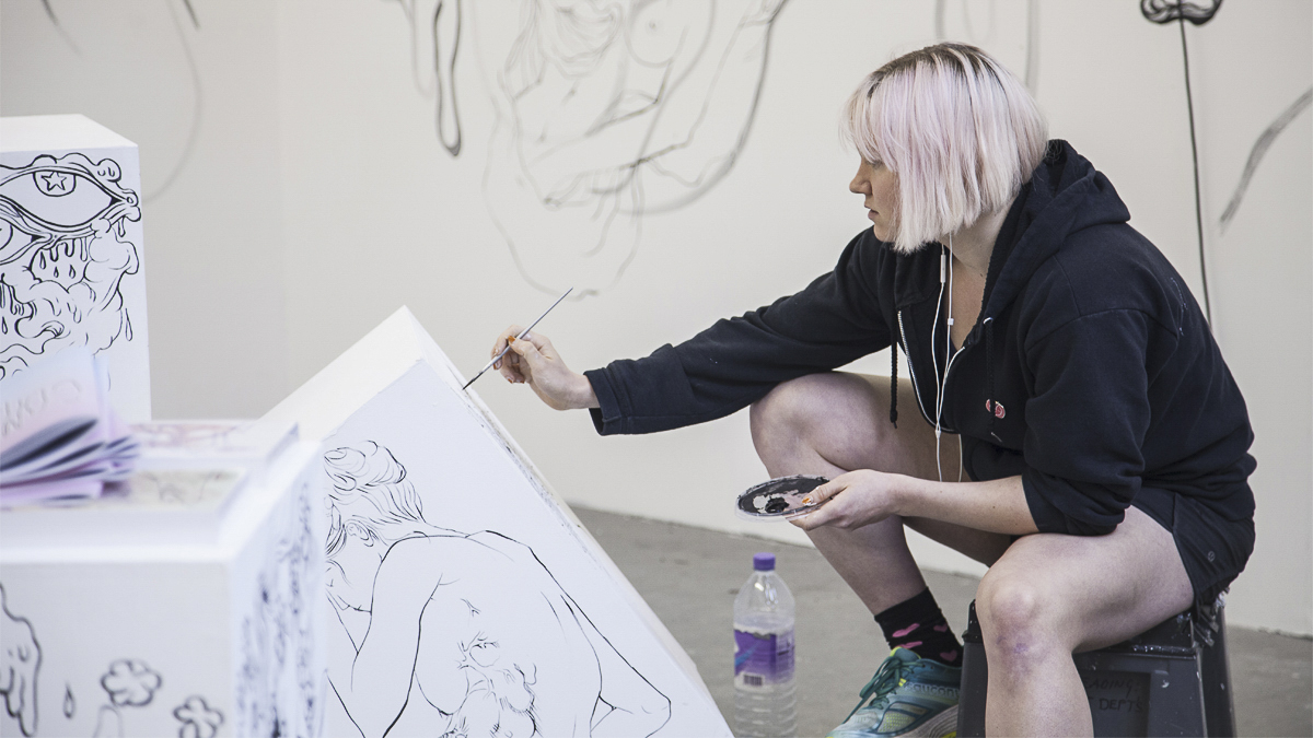 Student painting in a studio