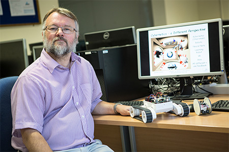 Richard Mitchell with a robot