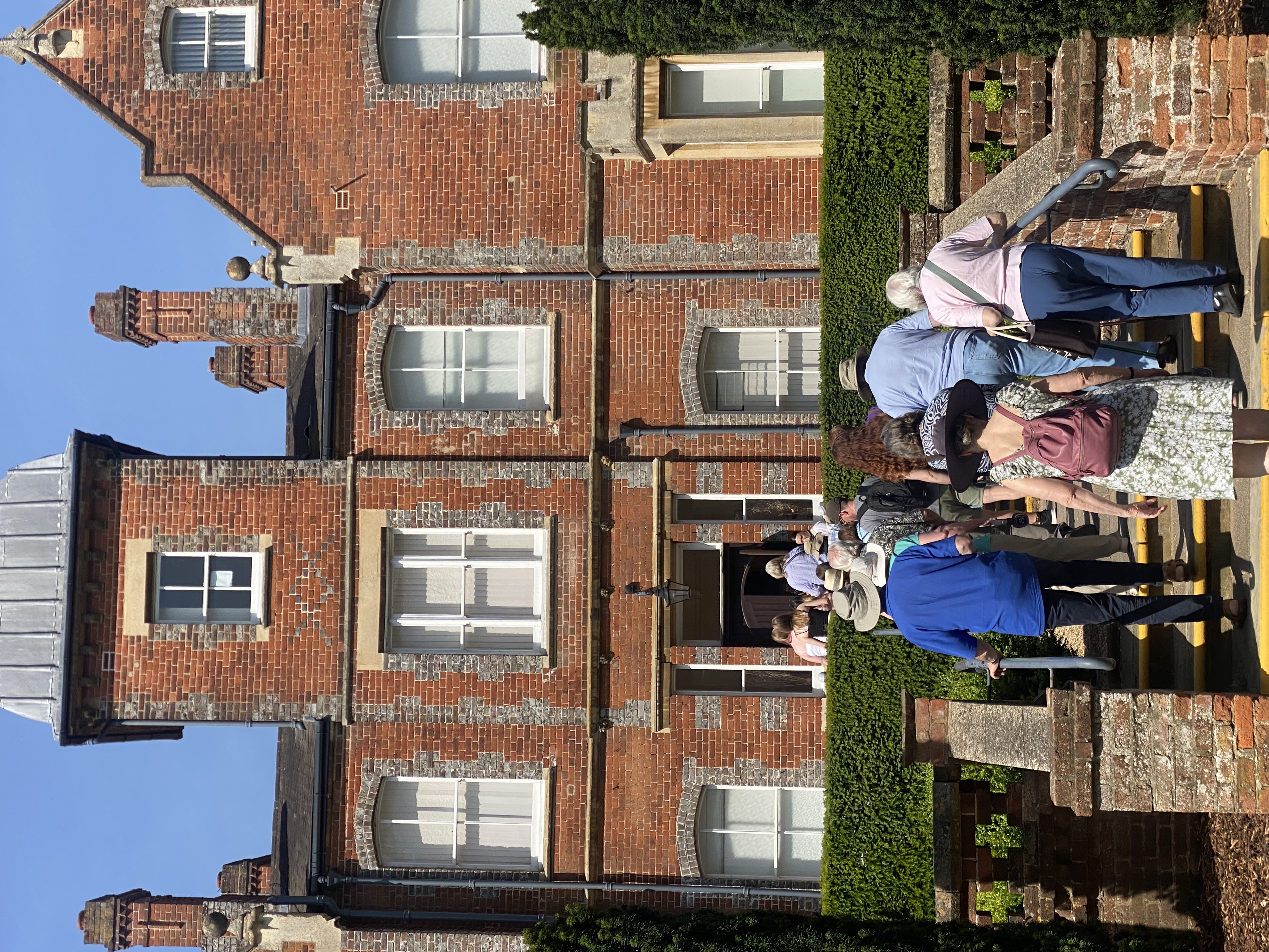 Tour group ascneding stone steps to old building