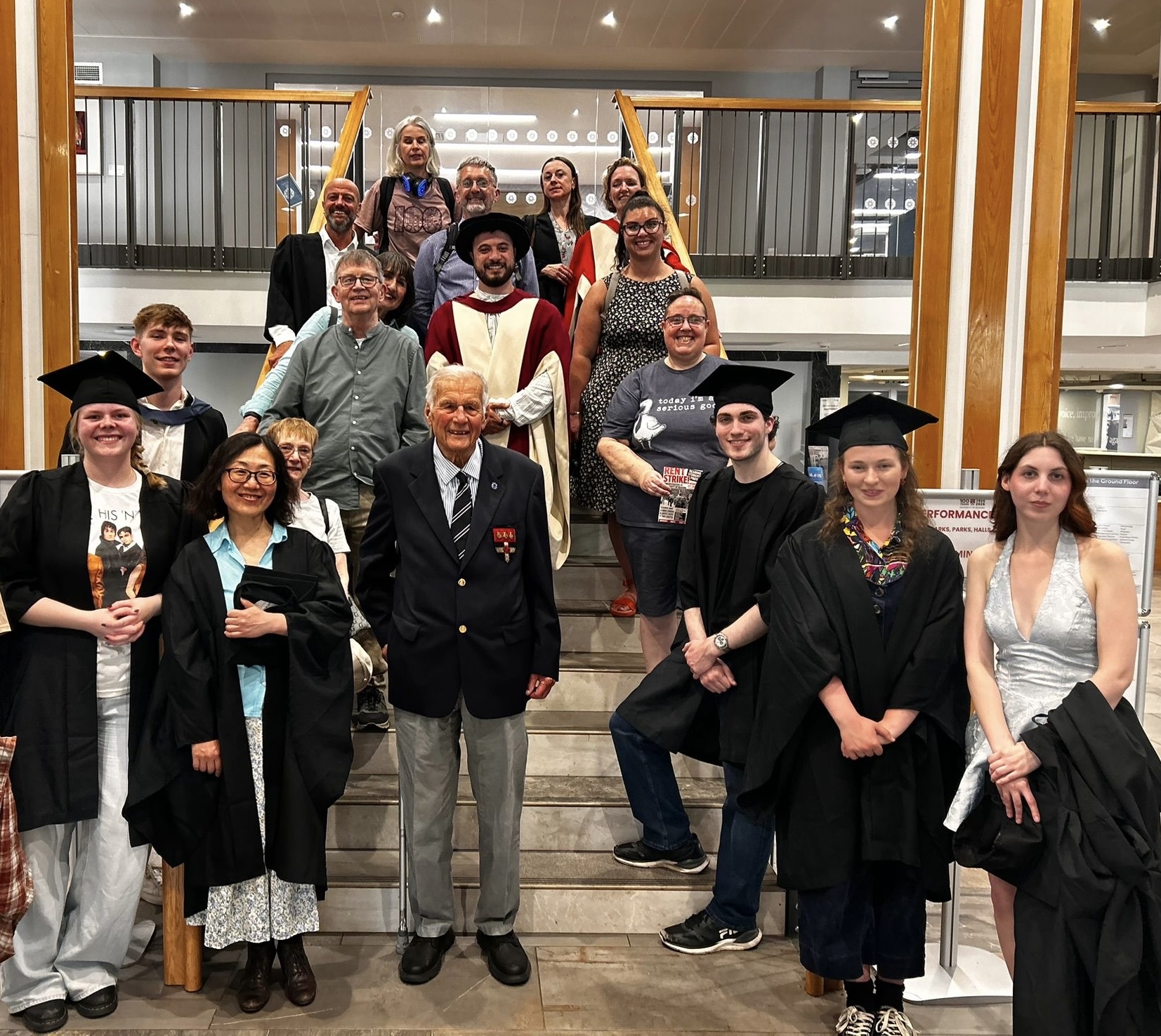 Graduands assembled on staircase with caps and gowns