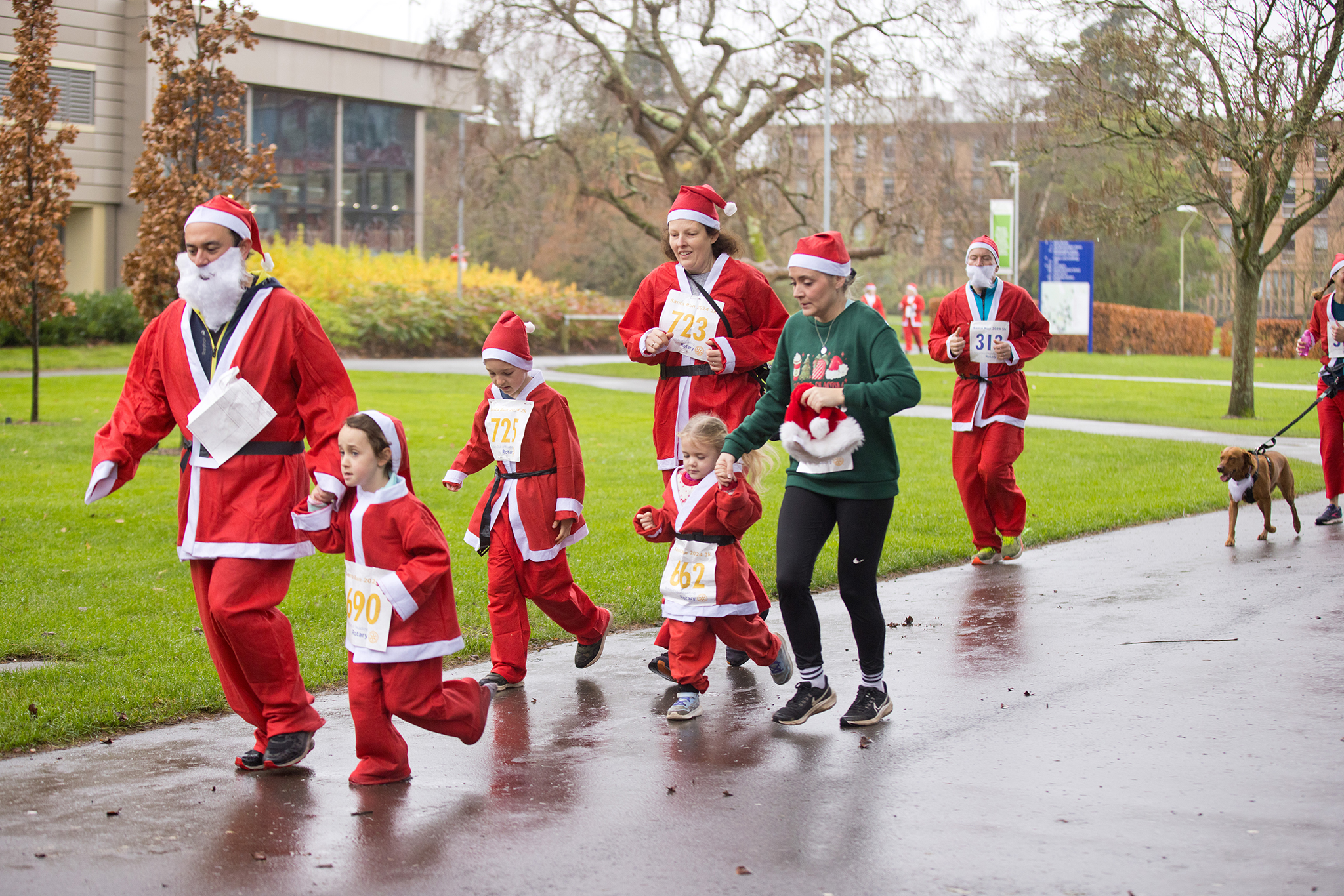 People of all ages taking part in a Santa Fun Run race