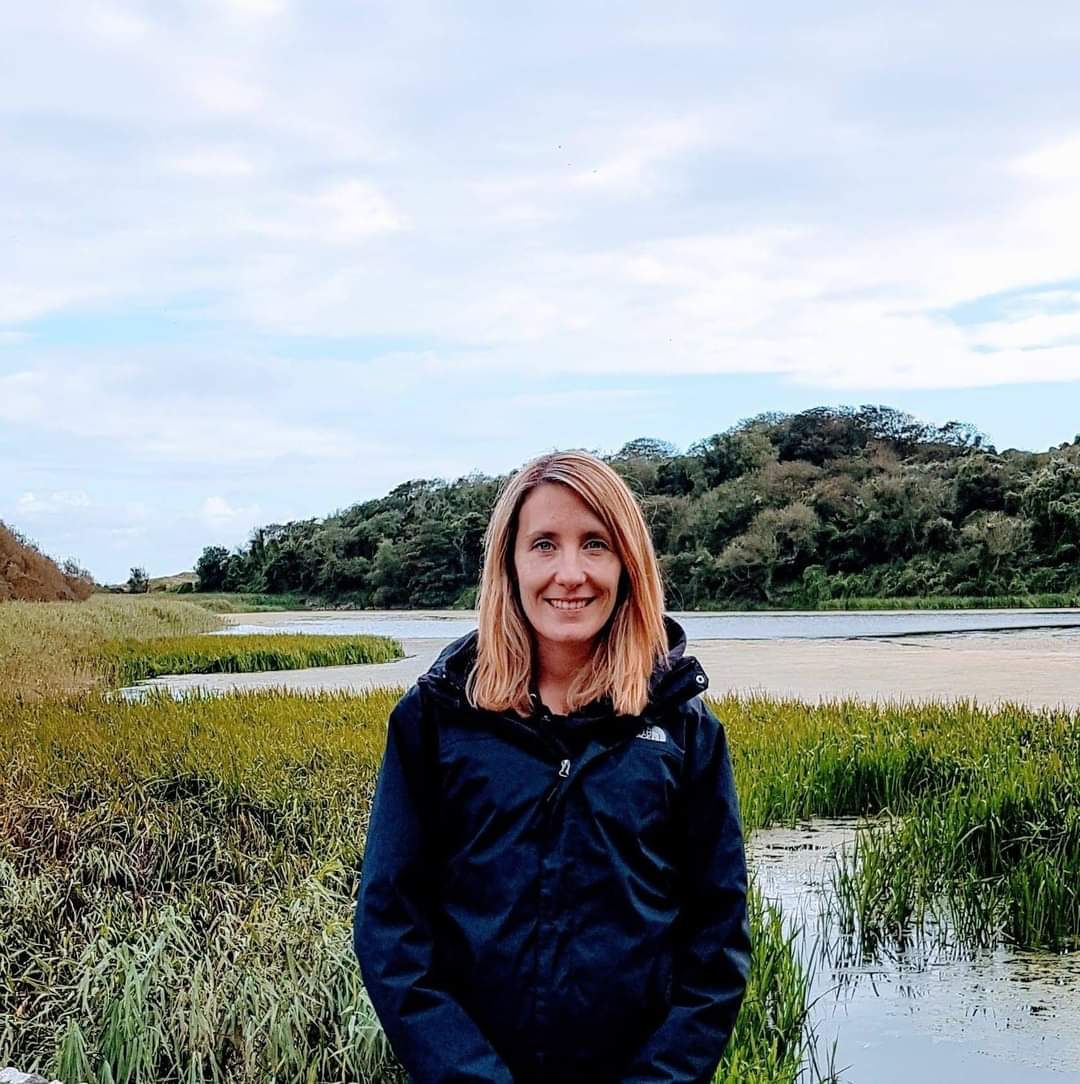 Headshot of Amelia Hollywood with countryside in the background