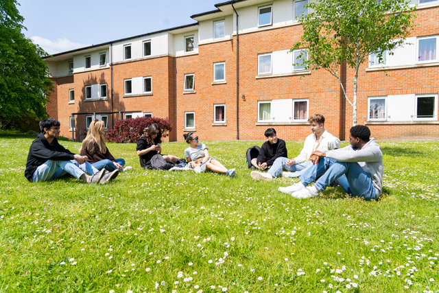 Students sat on grass outside of St George's Hall