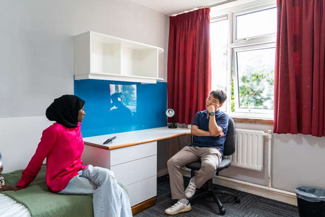 Two students talking in bedroom