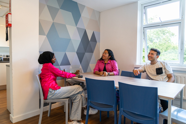 Students sat around table in communal area