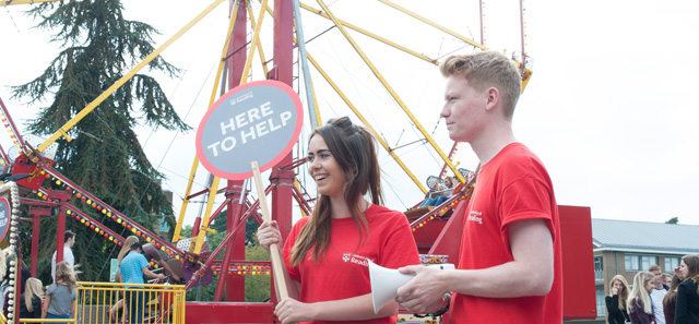 Students in front of a big wheel