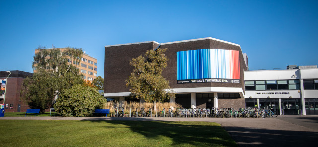 The Palmer Building with an image of the climate stripes